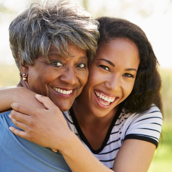 mom and daughter smiling