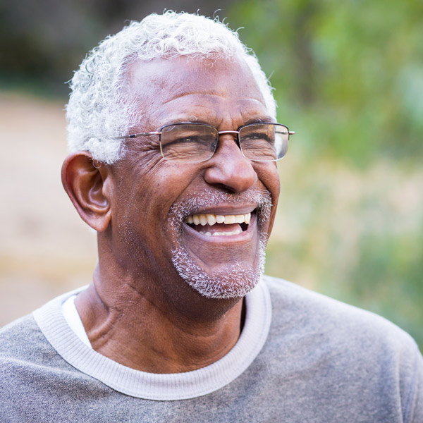 senior man in glasses smiling